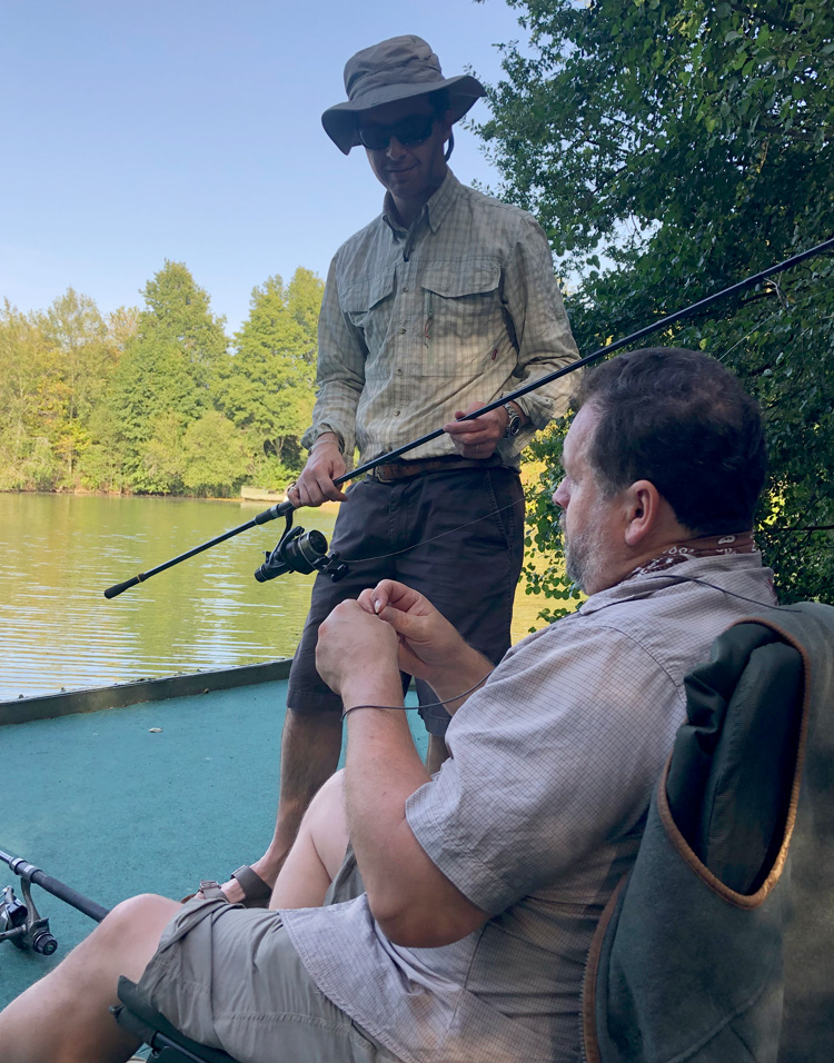 Shaun Harrison and Tim Pike discussing tactics at Quarry Bank Fishery, France