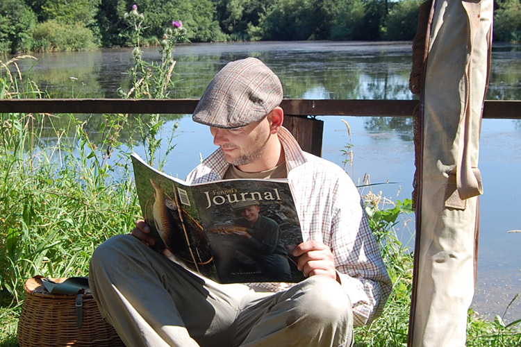 Stu Harris reading the early collector's edition magazine of Wild Carp by Fennel Hudson